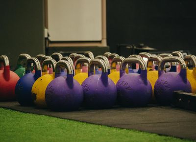 A simple kettlebell on a wooden floor, representing potential for strength.