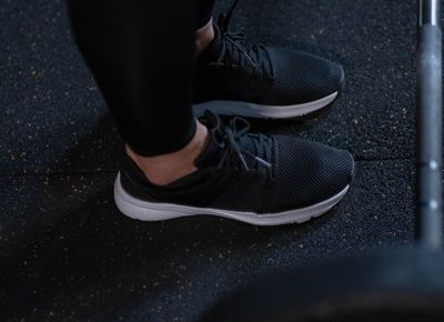 Close-up of athletic shoes on a gym floor, symbolizing stability.